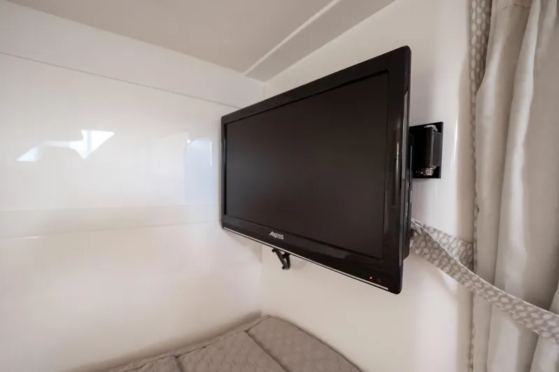 Slide: The Image of Flat-screen TV mounted in 2016 Intrepid 400 Cuddy cabin interior. - 90
