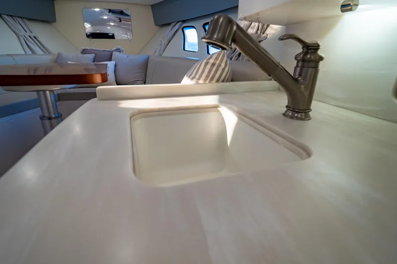 Slide: The Image of Luxurious interior of 2016 Intrepid 400 Cuddy yacht with modern sink and seating area. - 96