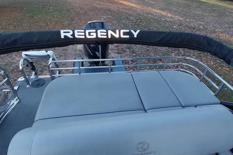 Slide: The Image of 2021 Regency 230 LE3 Sport pontoon boat with cushioned seating and railing. - 15