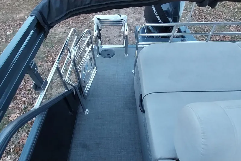 Slide: The Image of 2021 Regency 230 LE3 Sport boat interior with seating and railing. - 16