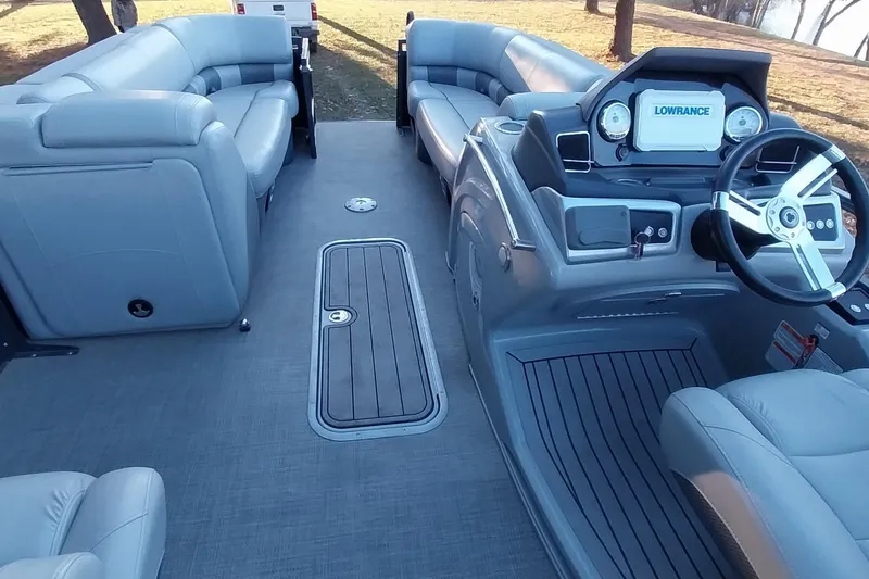 Slide: The Image of 2021 Regency 230 LE3 Sport pontoon boat interior with plush seating and modern dashboard. - 19