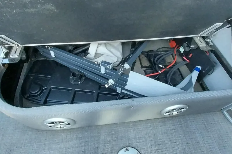 Slide: The Image of Storage compartment of a 2021 Regency 230 LE3 Sport boat with equipment and cables. - 22