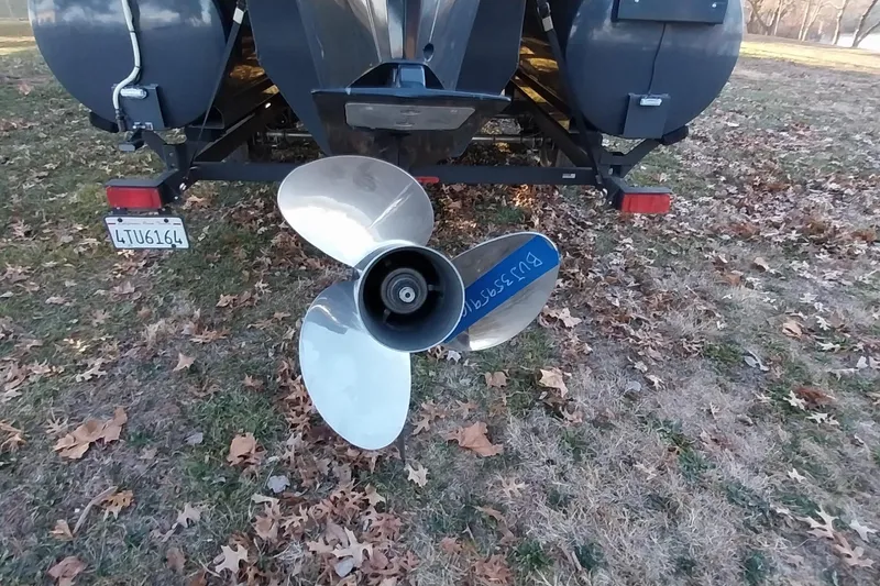 Slide: The Image of Rear view of a 2021 Regency 230 LE3 Sport boat with a shiny propeller. - 29