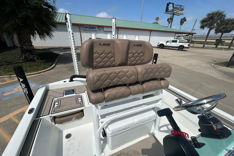 Slide: The Image of 2026 Avid 21 Mag boat interior with tan quilted seats and steering console. - 13