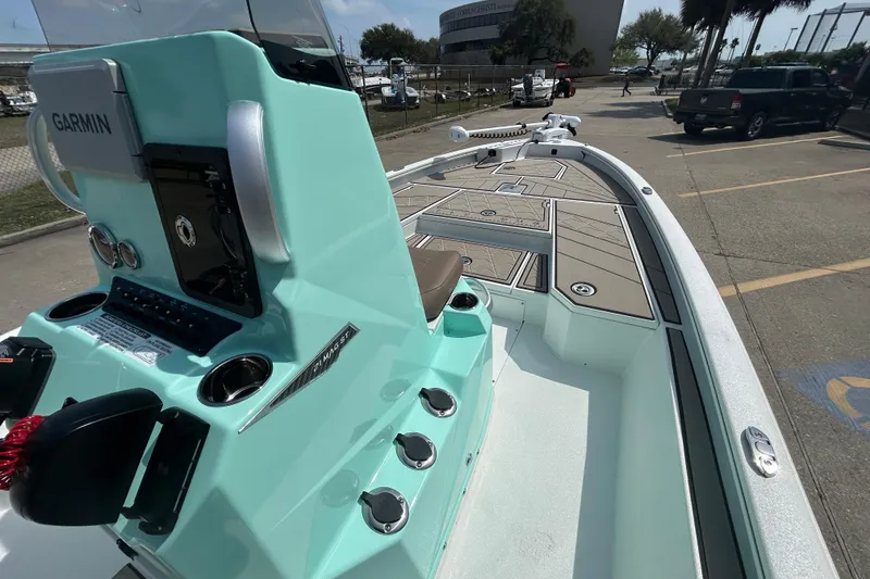 Slide: The Image of Avid 21 Mag 2026 boat with Garmin system, docked in a parking area. - 14