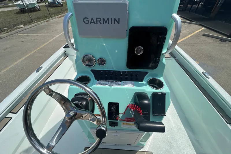 Slide: The Image of Avid 21 Mag 2026 boat console with Garmin navigation system and steering wheel. - 15