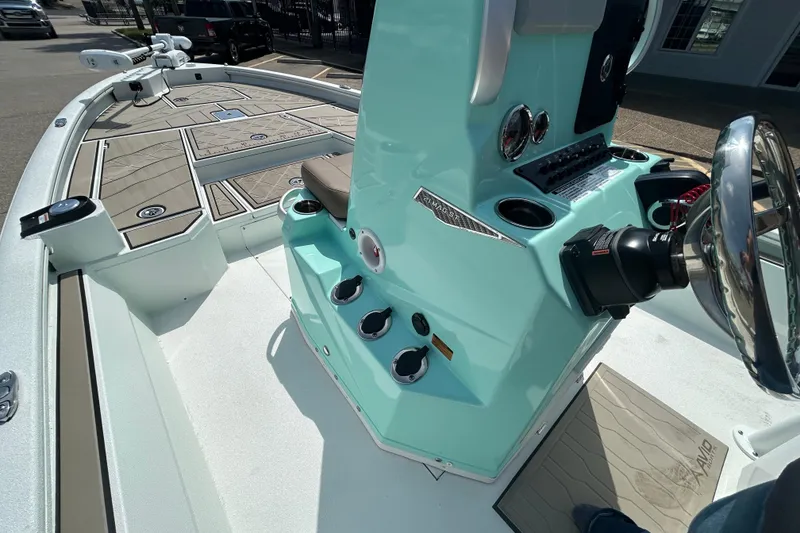 Slide: The Image of Avid 21 Mag 2026 boat interior with teal console and steering wheel. - 16