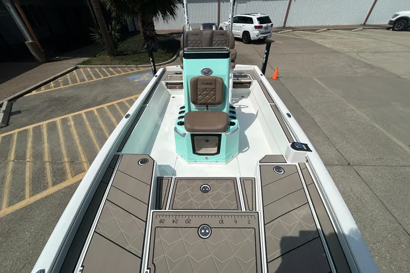 Slide: The Image of 2026 Avid 21 Mag boat interior with seating and deck details in a parking lot. - 19
