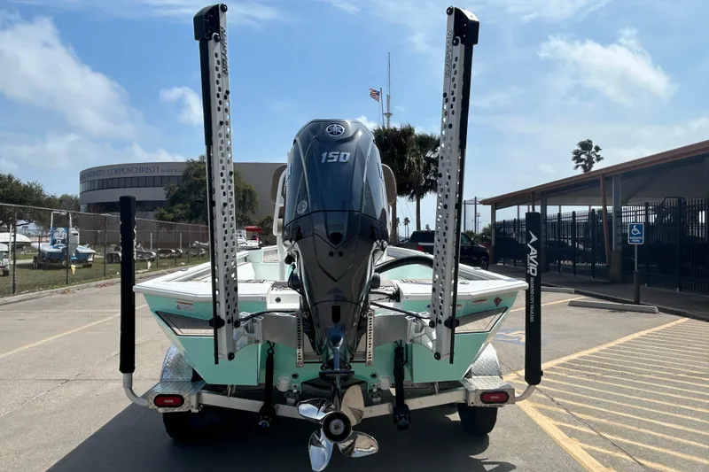 Slide: The Image of Avid 21 Mag 2026 boat with powerful outboard motor, parked near marina. - 6