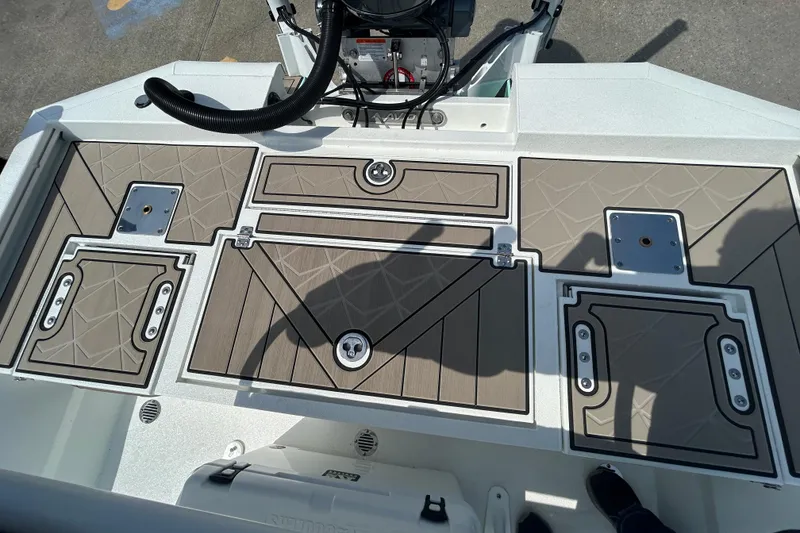 Slide: The Image of Avid 21 Mag 2026 boat deck with storage compartments and textured flooring. - 8
