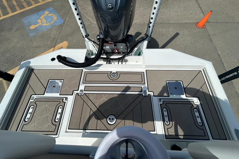 Slide: The Image of Avid 21 Mag 2026 boat deck with storage compartments and motor, viewed from above. - 9