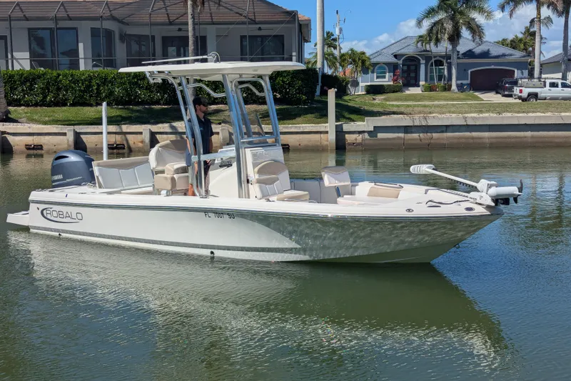 The Image of 2021 Robalo 226 Cayman boat docked in a serene waterfront setting. - 0