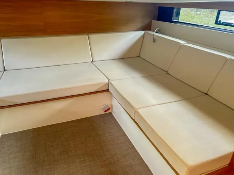 Slide: The Image of Interior seating area of 2023 De Antonio Yachts D42 Open with white cushions. - 18