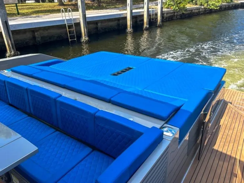 Slide: The Image of 2023 De Antonio Yachts D42 Open with blue cushioned seating on deck. - 26