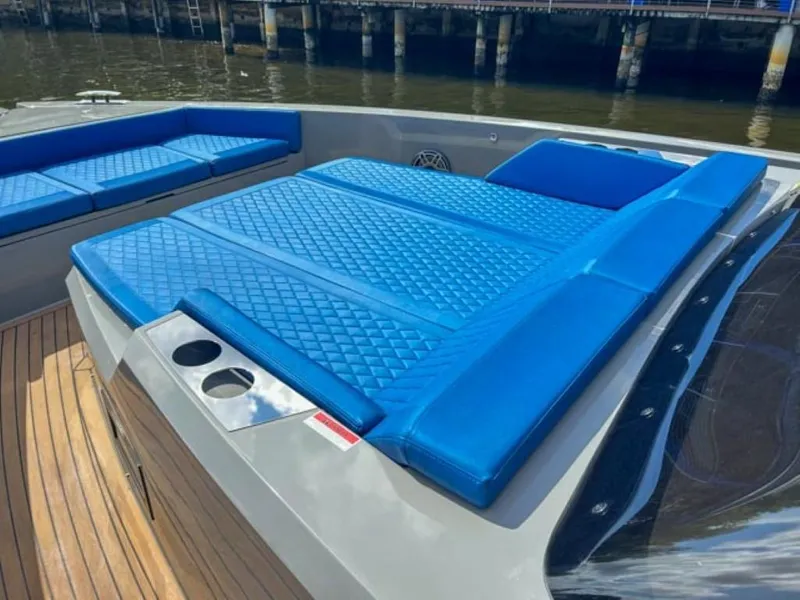 Slide: The Image of De Antonio Yachts D42 Open 2023 model with blue cushioned seating and sunbathing area. - 9