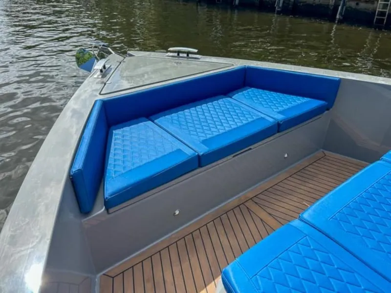 Slide: The Image of 2023 De Antonio Yachts D42 Open with blue cushioned seating and teak deck. - 10