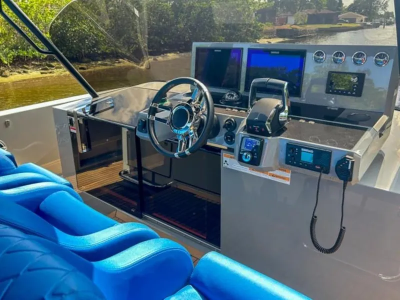 Slide: The Image of 2023 De Antonio Yachts D42 Open helm with modern controls and blue seating. - 12