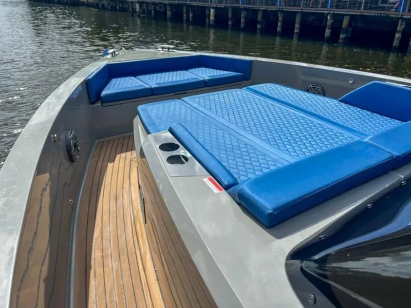 Slide: The Image of 2023 De Antonio Yachts D42 Open with blue cushioned seating and wooden deck. - 8