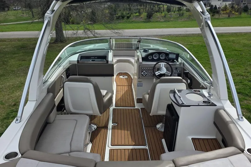 Slide: The Image of 2011 Sea Ray SLX 250 boat interior with luxurious seating and modern dashboard. - 11