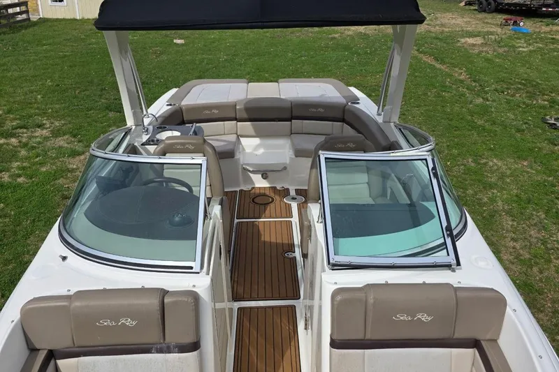 Slide: The Image of 2011 Sea Ray SLX 250 boat interior with tan seating and wooden flooring. - 12