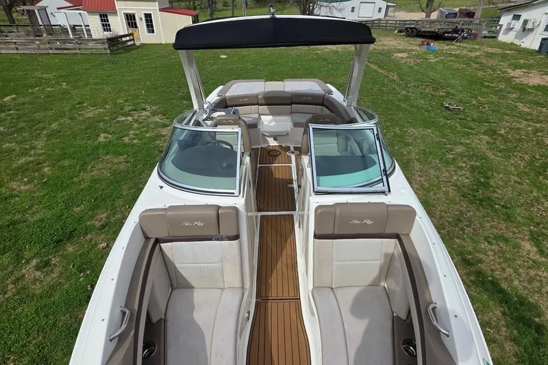 Slide: The Image of 2011 Sea Ray SLX 250 boat with spacious seating and sleek design on grassy area. - 13