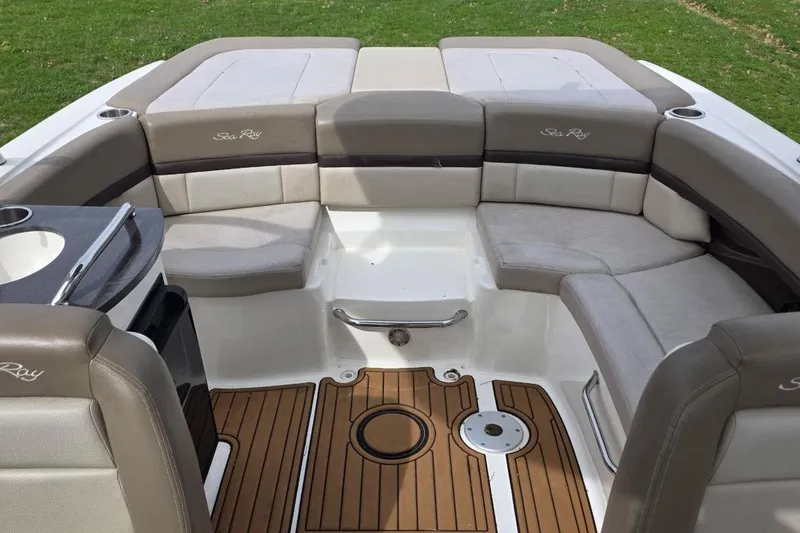 Slide: The Image of 2011 Sea Ray SLX 250 boat interior with cushioned seating and teak flooring. - 15
