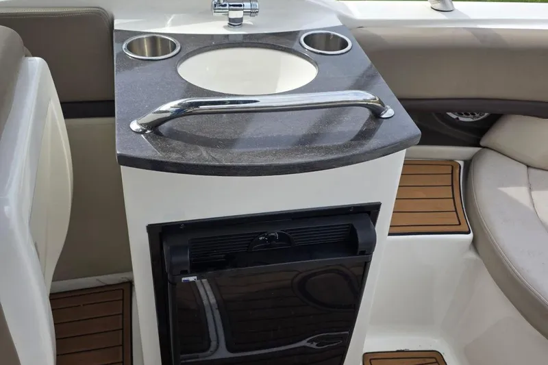Slide: The Image of Interior of 2011 Sea Ray SLX 250 boat with sink and mini fridge. - 16