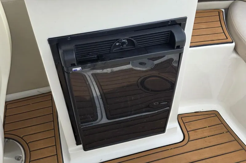 Slide: The Image of Built-in refrigerator on 2011 Sea Ray SLX 250 boat with teak flooring. - 17