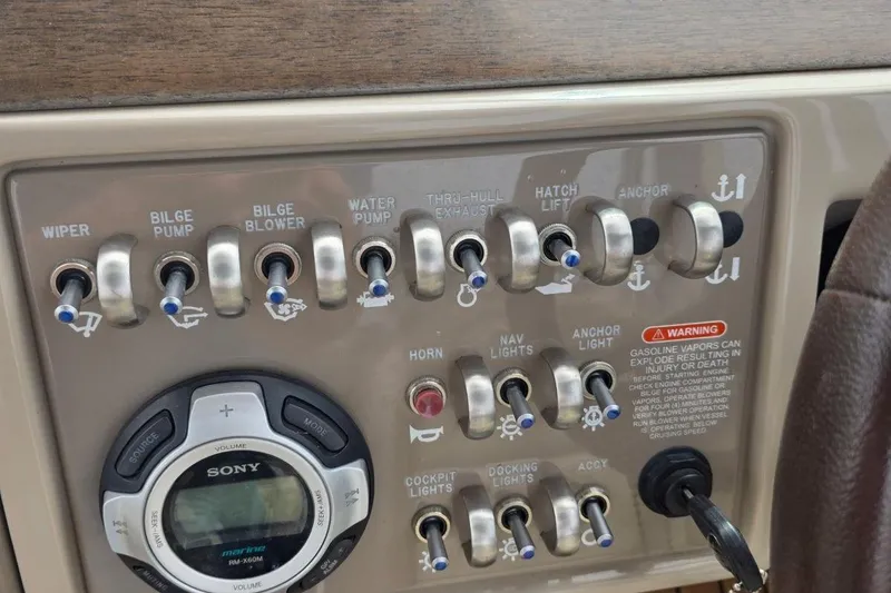 Slide: The Image of Control panel of a 2011 Sea Ray SLX 250 boat with switches and Sony stereo. - 22