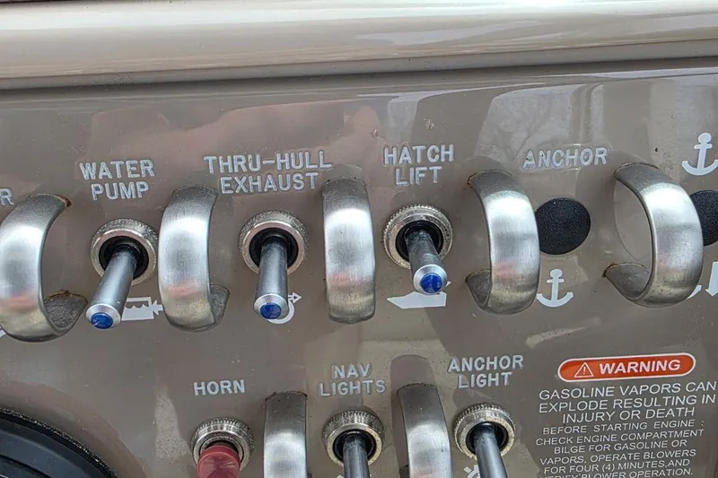 Slide: The Image of Control panel of a 2011 Sea Ray SLX 250 boat with labeled switches. - 23
