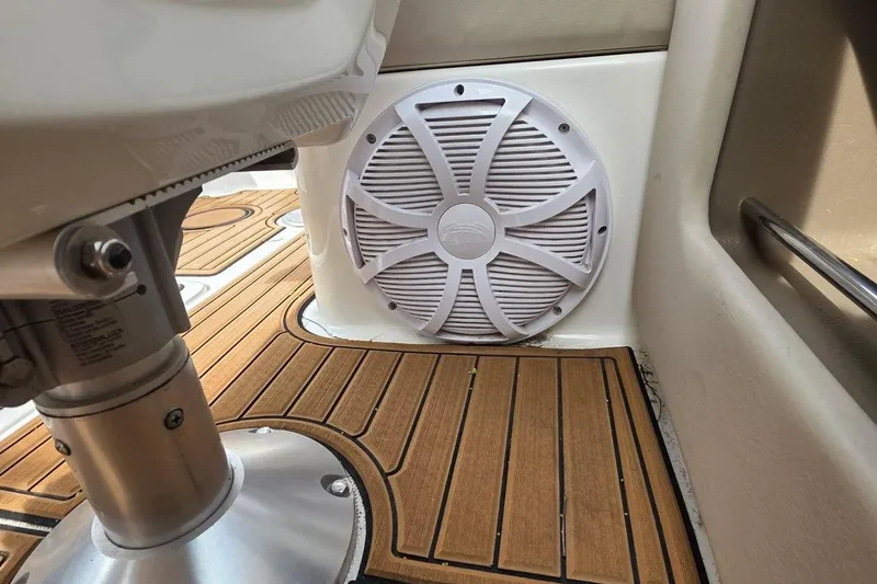 Slide: The Image of 2011 Sea Ray SLX 250 boat interior with speaker and teak flooring. - 24