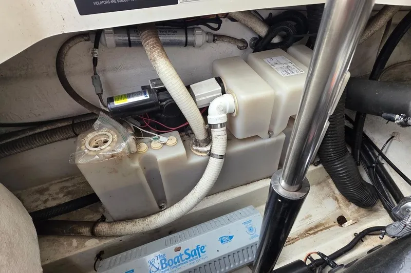 Slide: The Image of Engine compartment of a 2011 Sea Ray SLX 250 boat, showing various components and wiring. - 29