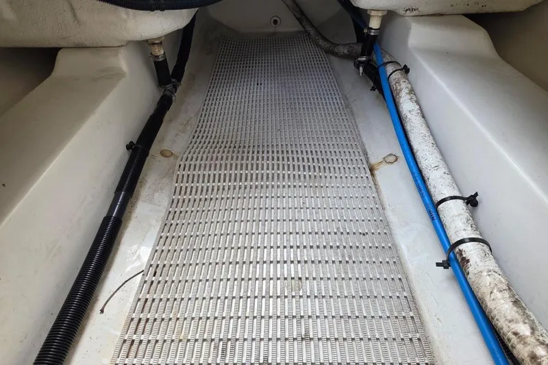 Slide: The Image of Interior view of a 2011 Sea Ray SLX 250 boat showing floor and pipes. - 31