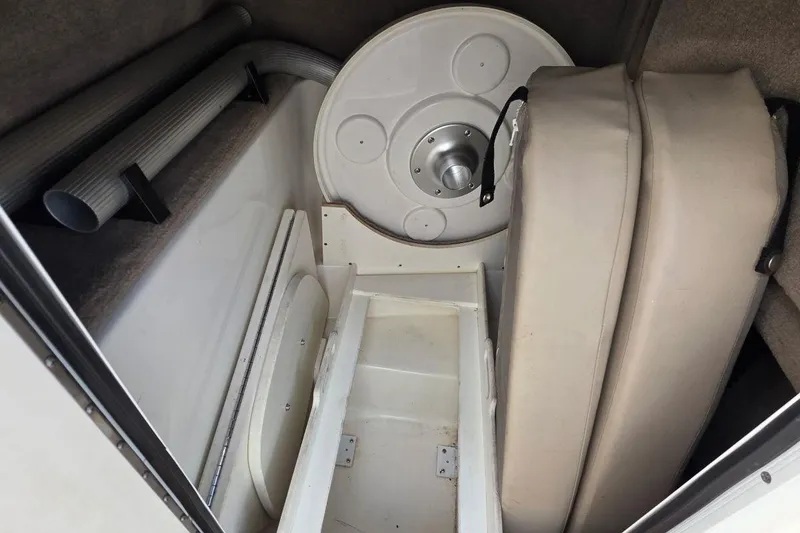 Slide: The Image of Interior storage compartment of a 2011 Sea Ray SLX 250 boat, featuring cushions and tubing. - 32