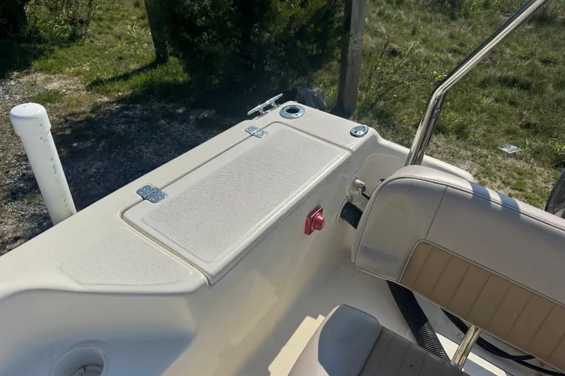 Slide: The Image of 2004 Scout 175 Dorado boat interior with seating and storage compartment. - 13