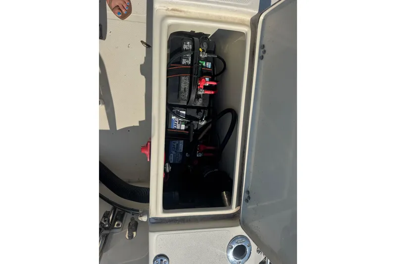 Slide: The Image of Battery compartment of a 2004 Scout 175 Dorado boat, showing wiring and connections. - 14