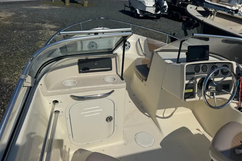 Slide: The Image of 2004 Scout 175 Dorado boat interior with steering wheel and dashboard controls. - 15
