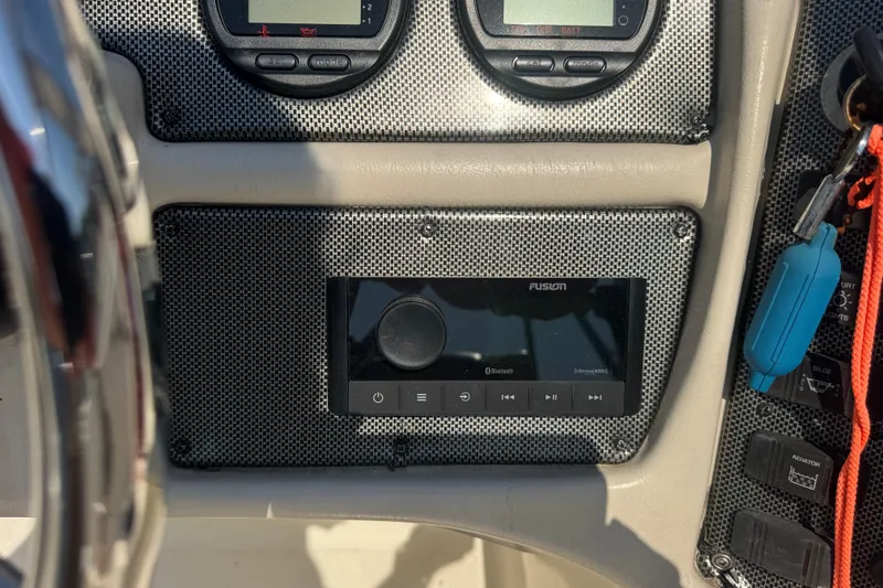 Slide: The Image of Dashboard of a 2004 Scout 175 Dorado boat featuring a Fusion audio system. - 16