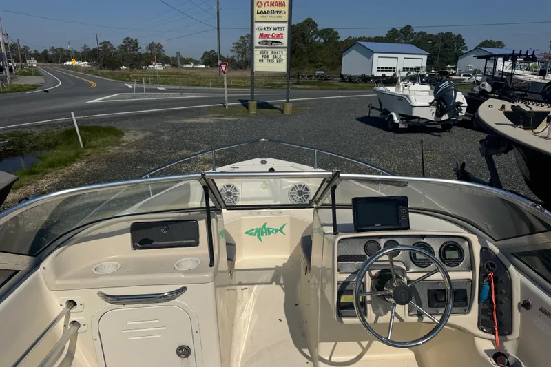 Slide: The Image of 2004 Scout 175 Dorado boat dashboard with steering wheel and navigation equipment. - 7