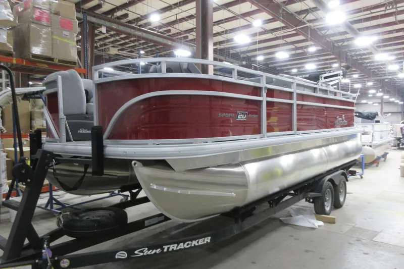 The Image of 2026 Sun Tracker SportFish 20 DLX pontoon boat in a warehouse setting. - 0
