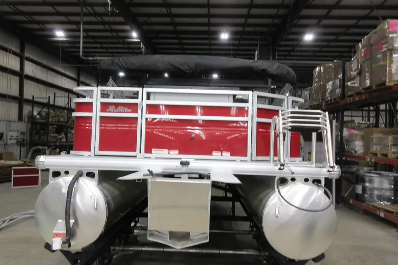 Slide: The Image of 2026 Sun Tracker SportFish 20 DLX pontoon boat in warehouse setting. - 3