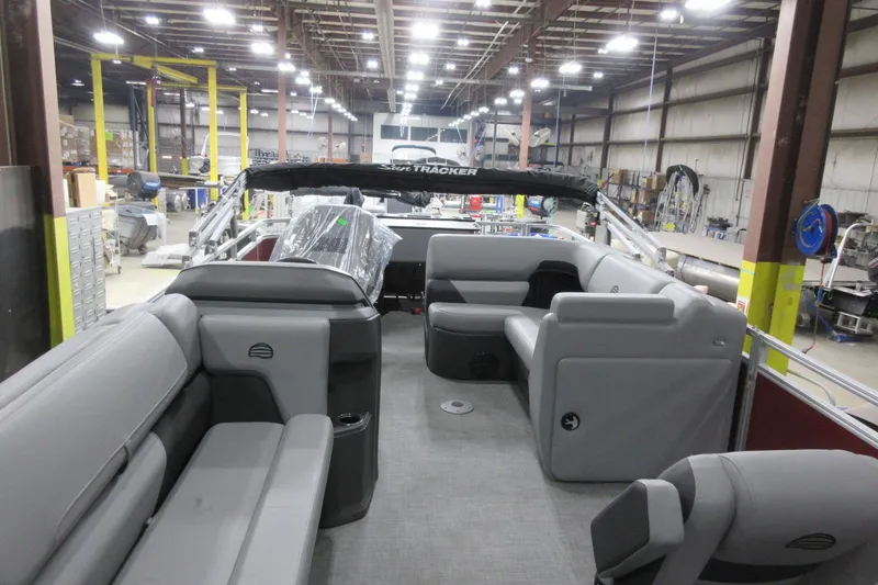 Slide: The Image of 2026 Sun Tracker SportFish 20 DLX pontoon boat interior in a factory setting. - 4