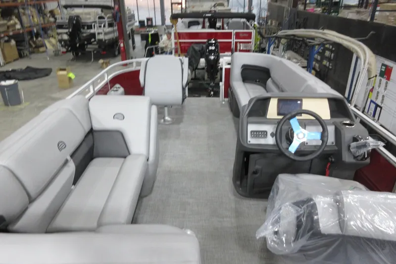 Slide: The Image of 2026 Sun Tracker SportFish 20 DLX pontoon boat interior with gray seating and modern dashboard. - 5
