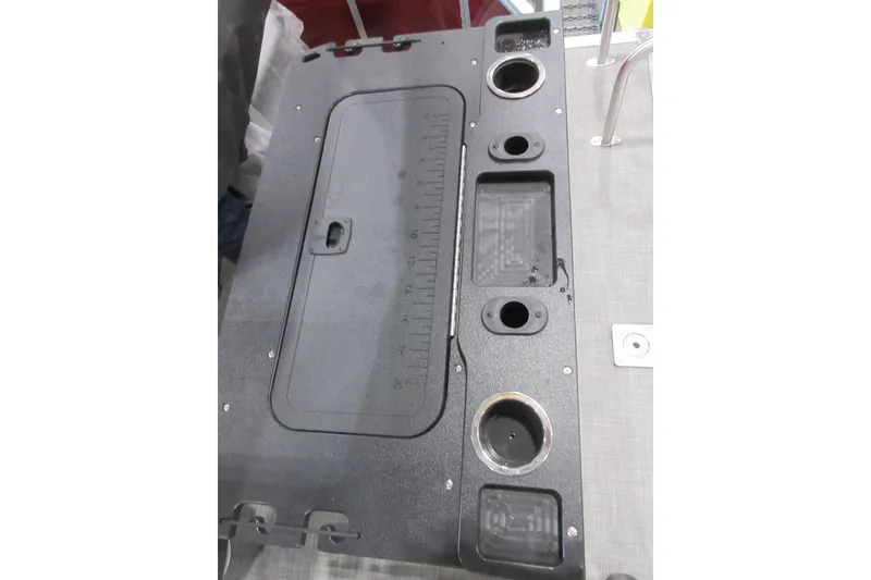 Slide: The Image of Control panel of 2026 Sun Tracker SportFish 20 DLX boat with cup holders and storage compartments. - 6