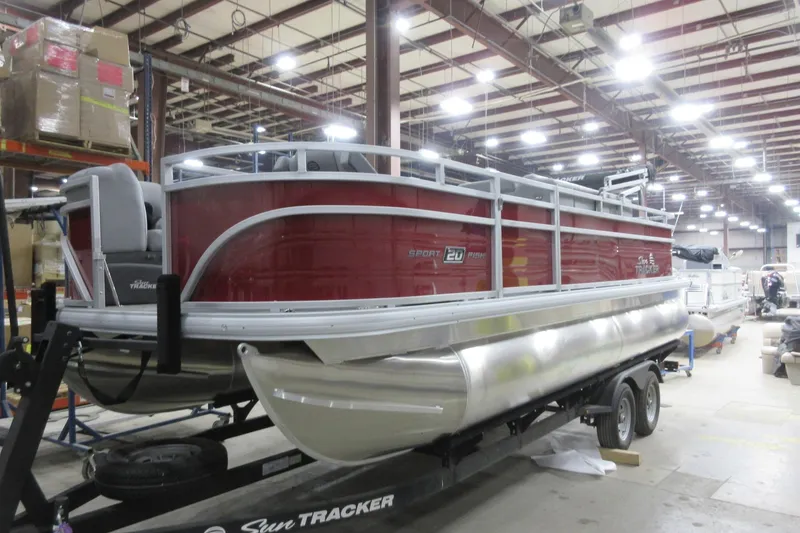 Slide: The Image of 2026 Sun Tracker SportFish 20 DLX pontoon boat in a warehouse setting. - 8