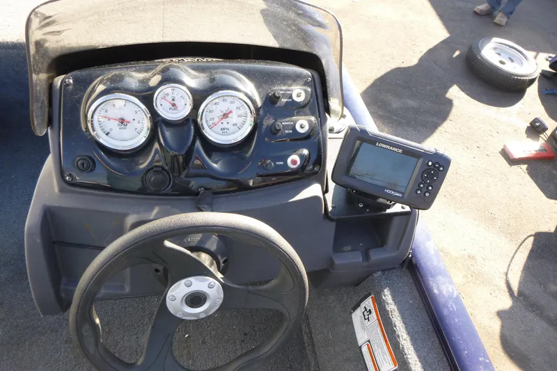 Slide: The Image of 2021 Tracker Pro 170 dashboard with gauges and Lowrance fishfinder. - 11