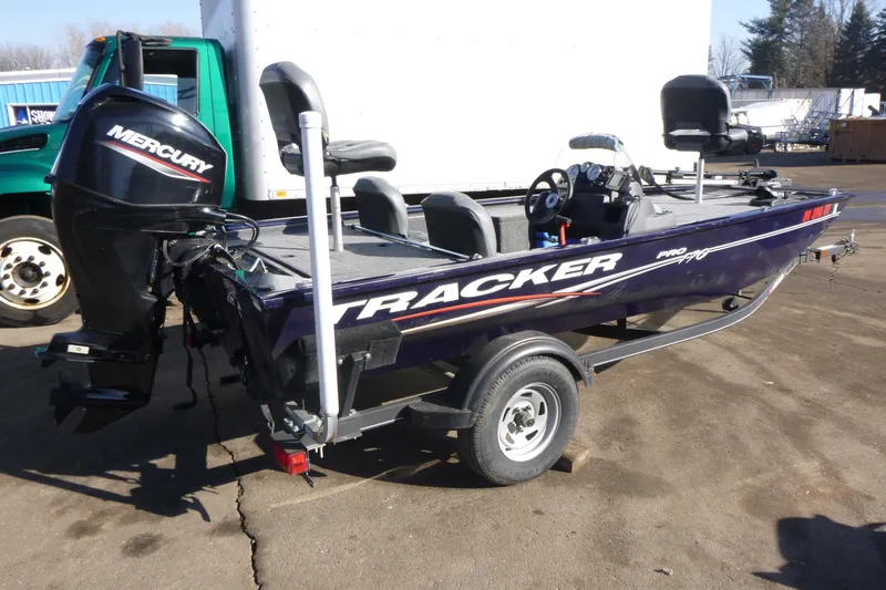 Slide: The Image of 2021 Tracker Pro 170 boat with Mercury engine on trailer, parked outdoors. - 4