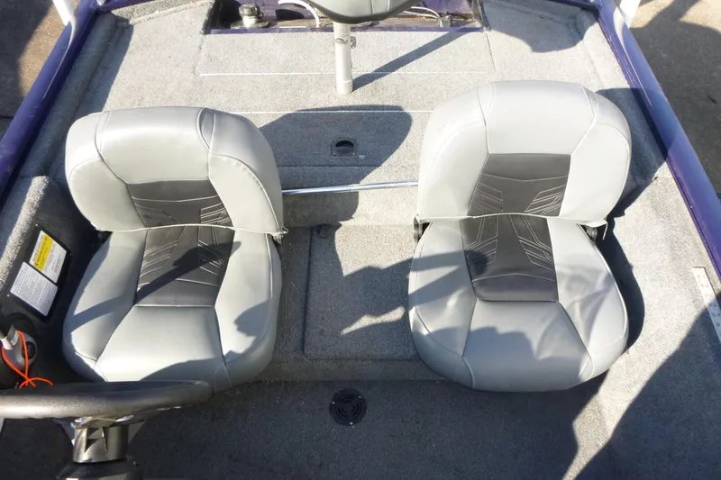 Slide: The Image of 2021 Tracker Pro 170 boat interior with two gray seats and steering wheel. - 9