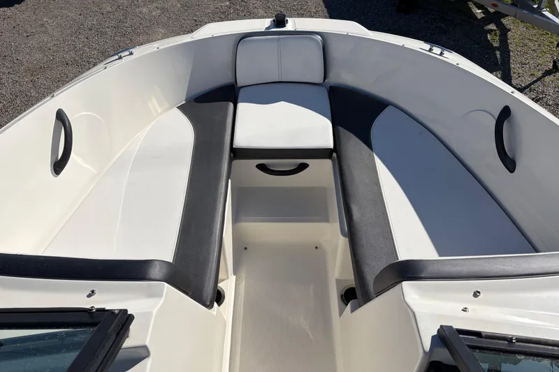Slide: The Image of 2015 Sea Ray 19 SPX boat interior with white and black seating. - 13