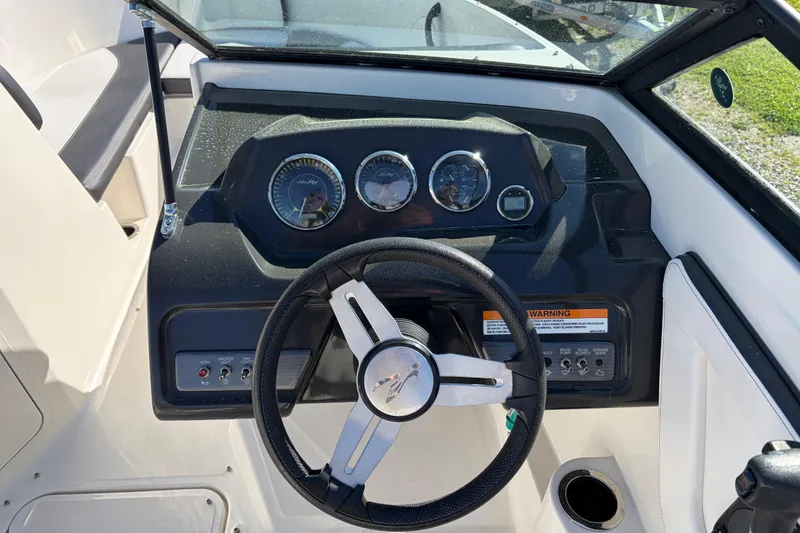 Slide: The Image of 2015 Sea Ray 19 SPX boat dashboard with steering wheel and instrument panel. - 15